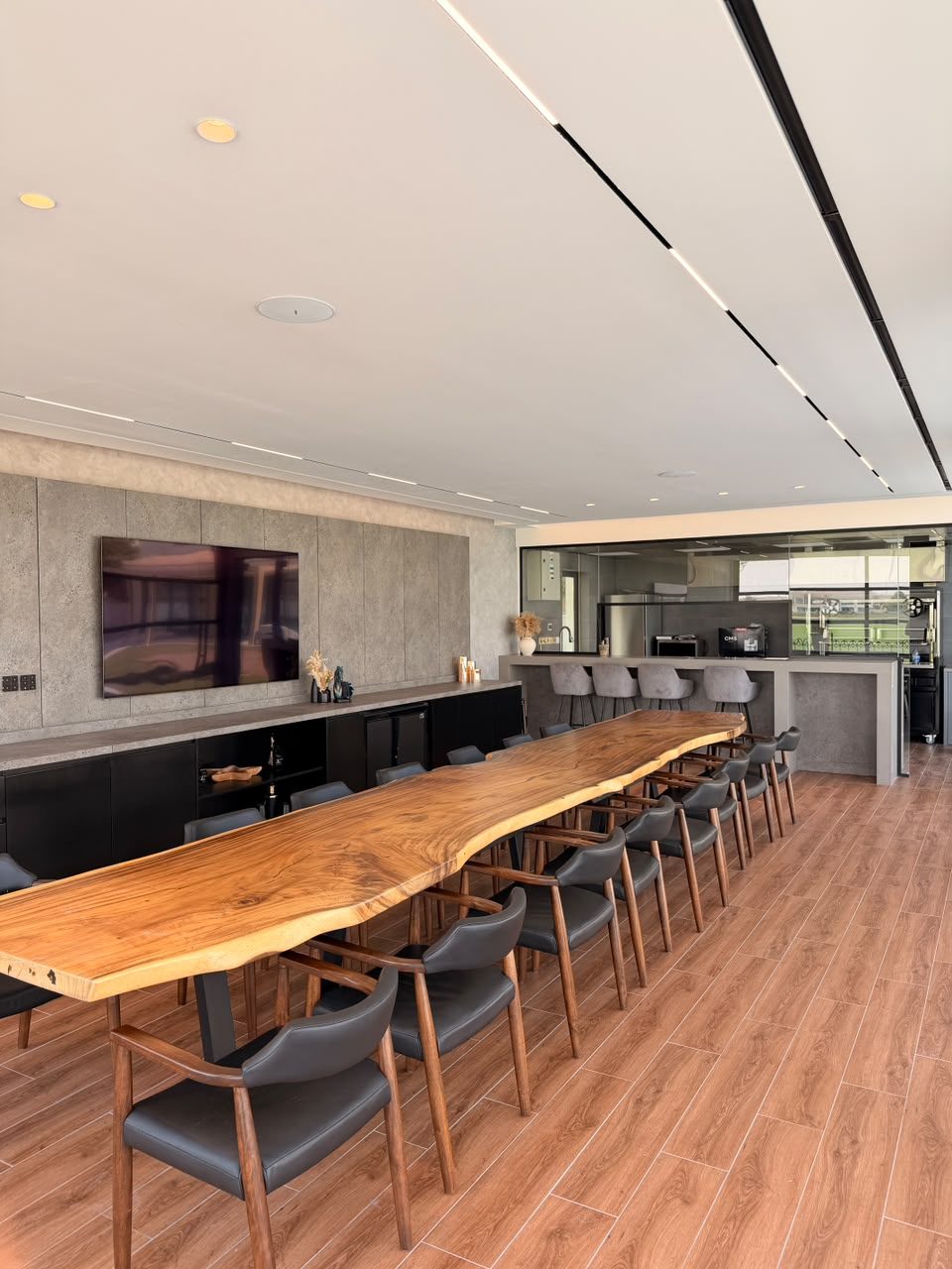 Dining room at the Polo Homes villa, linear lighting over a long timber table